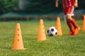 A row of Football Training Cones. Young Soccer Player Running Fast and Kicking Football Ball Royalty Free Stock Photo