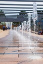 Row of fountains in a park at a high shutter speed freezing the motion of the water and suspended droplets with variety of shape,