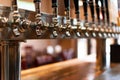 Row of four beer taps arranged on a bar counter