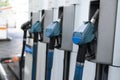 A row with four blue gas pump nozzles Royalty Free Stock Photo