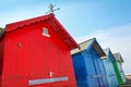 Row of four colourful beach huts. Royalty Free Stock Photo