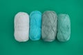 A row of four cotton skeins - white, light blue, olive and light Royalty Free Stock Photo