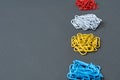 Row of four heaps of paper clips red, blue, yellow and white colors for office work or education Royalty Free Stock Photo