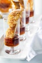 A row of french toast finger food appetizers in shot glasses with maple syrup. Royalty Free Stock Photo