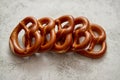 Row of fresh baked brown salty pretzel bread