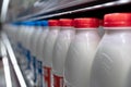 Row of fresh milk bottles in fridge, food store, nobody Royalty Free Stock Photo