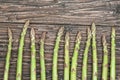 Row of fresh raw green Asparagus on wooden table Royalty Free Stock Photo