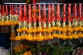 Row of fresh Thai style flower garlands made of white jasmine and crown flower and yellow marigold with red decorative ribbon Royalty Free Stock Photo