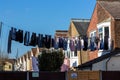 A row of gardens and terraced houses with a washing line with clothes hanging from it drying them Royalty Free Stock Photo