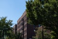 Row of Generic Old Brick Apartment Buildings with Fire Escapes in Astoria Queens of New York City Royalty Free Stock Photo