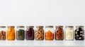 A row of glass jars filled with assorted dried fruits, perfect for snacking. Royalty Free Stock Photo