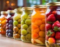 A row of glass jars filled with an assortment of canned fruits