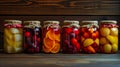 A row of glass jars filled with an assortment of canned fruits, showcasing the colorful variety of preserved produce Royalty Free Stock Photo