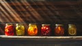 A row of glass jars filled with an assortment of canned fruits, showcasing the colorful variety of preserved produce Royalty Free Stock Photo