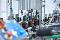 Row of glass wine bottles moving by conveyor Royalty Free Stock Photo