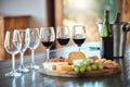 A row of glasses and a cheese board set up for a wine tasting inside a restaurant. A cheese platter the right wine is Royalty Free Stock Photo