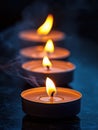 Row of Glowing Candles with Flickering Flames in Dark Still Life Royalty Free Stock Photo