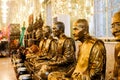 Row of gold buddha statue in Mosaic sanctuary Glass Chapel at Wat Muang, Angthing, Thailand. Beautiful of historic city at
