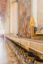 Row of golden Buddist alms bowls in Wat Pho Wat Phra Chetuphon temple in Bangkok Royalty Free Stock Photo