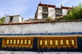 A row of prayer wheels adorn Deprung Monastery.