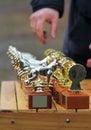 Row of golden trophy cups for dog competition. Russian lettering saying `to the smartest` and `to the most fearless`