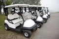 Row of golf carts in the fog Royalty Free Stock Photo