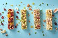 A row of granola bars with nuts and fruit on a blue background.AI generated Royalty Free Stock Photo