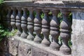 A row of gray stone balusters.