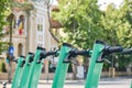 Row of green-blue electric scooters, a cleaner, modern alternative transportation option in cities. Close up
