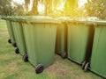 A row of green dustbin with sun flare.Pollution concept. Royalty Free Stock Photo