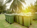 A row of green dustbin with sun flare.Pollution concept. Royalty Free Stock Photo