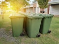 A row of green dustbin with sun flare.Pollution concept. Royalty Free Stock Photo