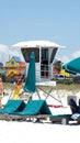 Row of green lounge chairs by a lifeguard stand Royalty Free Stock Photo