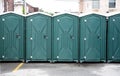 Row of Green Portable Toilets