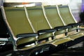 A row of green seats at the airport. Waiting hall.Passenger seats in departure lounge at airport terminal. Interior of airport ter Royalty Free Stock Photo