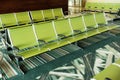 A row of green seats at the airport. Waiting hall.Passenger seats in departure lounge at airport terminal. Interior of airport ter Royalty Free Stock Photo