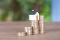 A row of growing euro coins and a miniature house mode Royalty Free Stock Photo