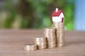 A row of growing euro coins and a miniature house mode Royalty Free Stock Photo