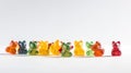 a row of gummy bears sitting next to each other on a white surface with one bear in the middle of the row of gummy bears Royalty Free Stock Photo