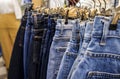 Row of hanged blue jeans skirts in night market