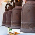 Row of hanging buddhist religious bells in Thailand temple Royalty Free Stock Photo