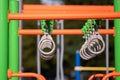 Row of a hanging rings for climbing on a kids playground.