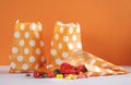 Row of Happy Halloween orange polka dot trick or treat paper bags Royalty Free Stock Photo