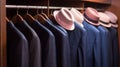 a row of hats hanging on a coat rack next to a row of suits and shirts on hangers in a closet with wooden walls