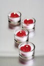 Row of heart-shaped tealights in candle holders Royalty Free Stock Photo