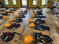 Row of helmets and harnesses ready for use at a high ropes and climbing course.