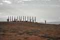 ritual Buryat religious pillars tied with colored ribbons, against the background of a warm sunset sky in the Baikal steppe