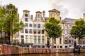 Row of historic houses with ornate Bell and Neck Gables along the Herengracht Gentlemens Canal in Amsterdam Royalty Free Stock Photo