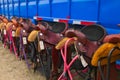 Row of horse saddles on display at county fair Royalty Free Stock Photo