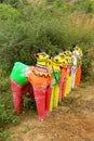 A row of horse statues at a indian village temple complex.